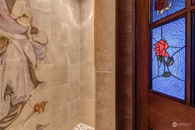 Hand painted design in the tiled walk-in shower.