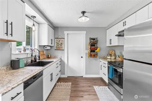 Beautiful kitchen overlooking the giant backyard. Door leads to the laundry and bonus rooms