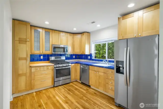 The kitchen is well configured with all stainless steel appliances and wood cabinets.