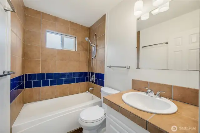 The full bathroom is set between the two bedrooms and is a good size for the house.  It has ceramic tile on the floor and shower.
