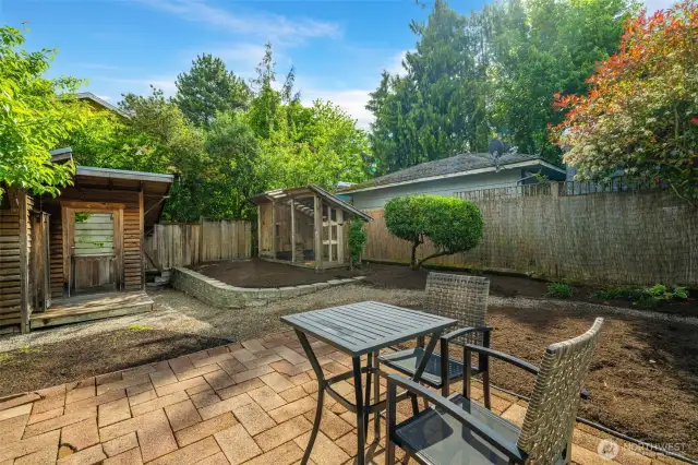 The backyard will be your oasis of relaxation!  It includes a brick patio, a building that could be used as your art studio or gardening shed and (wait for it) your big, beautiful chicken coop for those eggs!