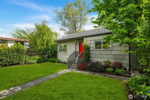The fully fenced back yard has gates on either side of the house.