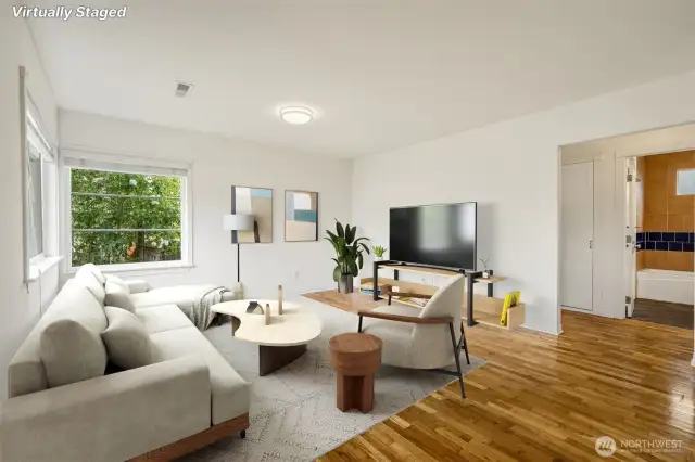 In this photo it is easy to see the oak hardwood floors and the large picture windows on two sides of the living room that keep the room well lit during our winter days!