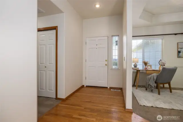 Entrance with oak flooring, hallway to bedrooms to left, den/office to right.