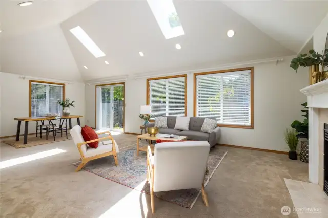 Soaring ceilings and skylights bring in the light to this main level living space.