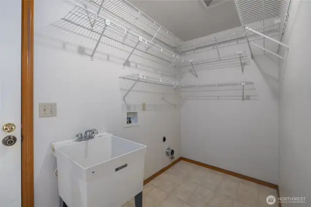 Convenient laundry area and utility sink off of garage back entrance.