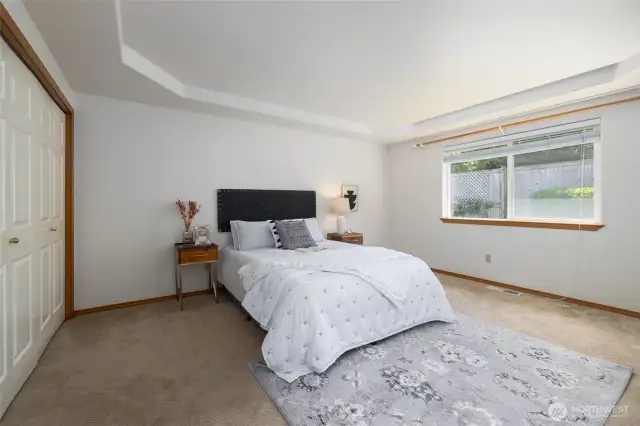 Primary bedroom is tucked away in a quiet corner near the back garden.