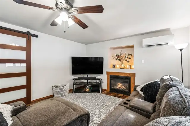 Family room view, modern barn door to your left leads to utility and garage.
