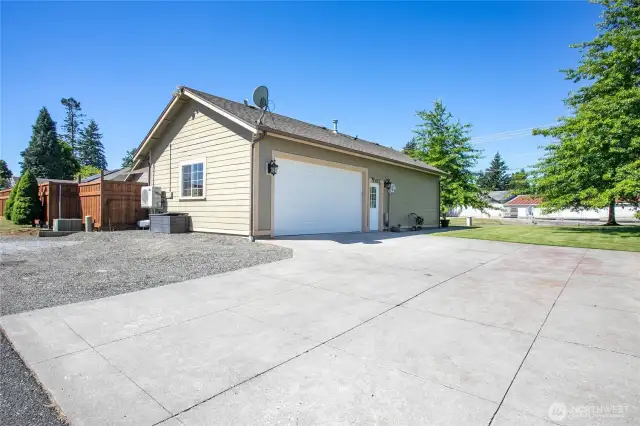 Two car garage and large driveway with extra parking