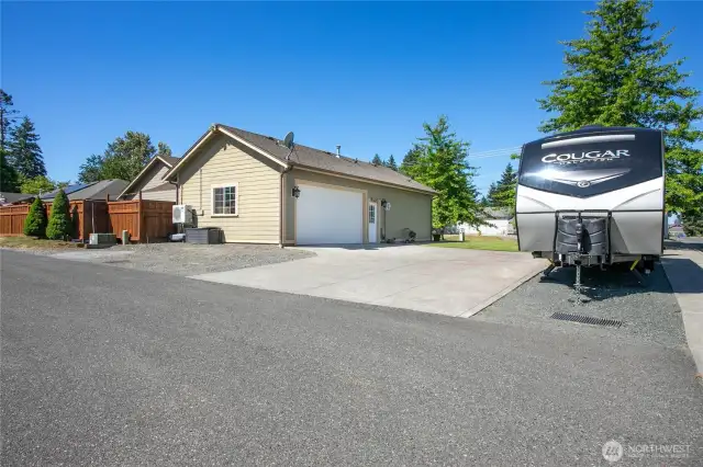 Two car garage and driveway with trailer parking