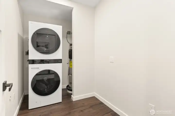 Stackable washer and dryer and plenty of room for a folding table or more storage.