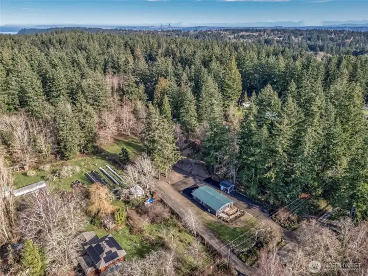 aerial view with property extending back beyond the clearing.