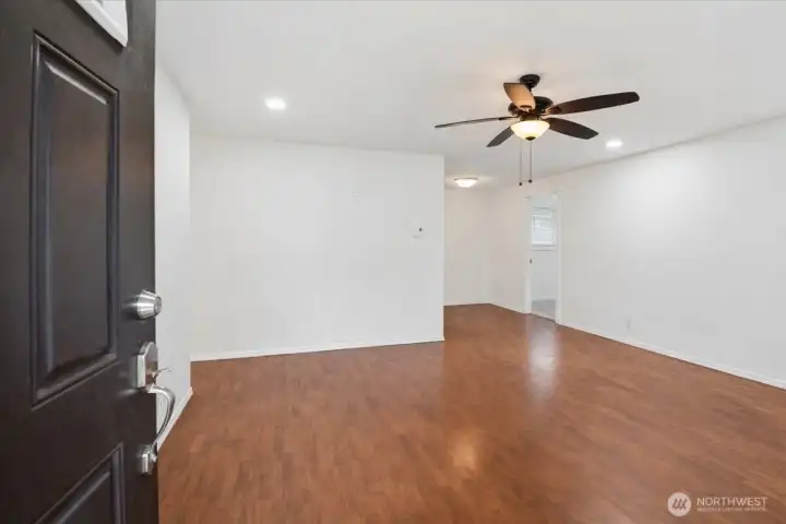 Spacious living room with hard flooring.