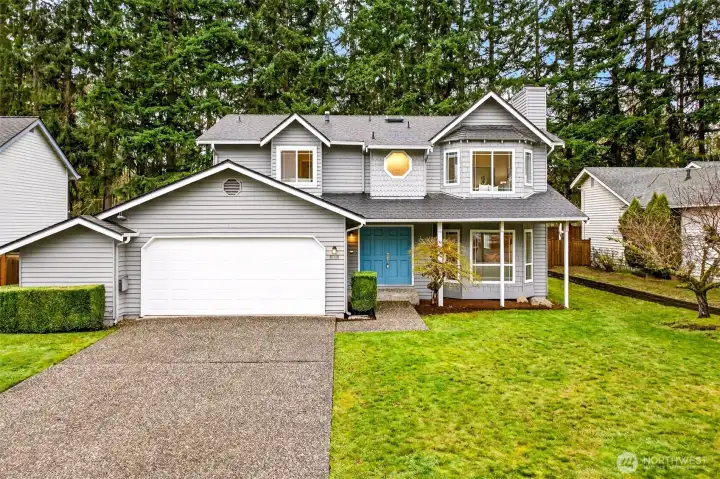 Set against a backdrop of towering Pacific Northwest evergreens, this well-proportioned two-story home offers a commanding street presence, a generous front lawn, and a two-car garage — all in one of Redmond's most desirable English Hill addresses.