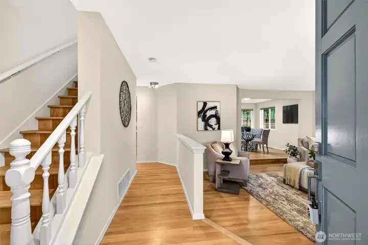 Step inside to a gracious foyer where refinished hardwood floors, fresh neutral paint, and an open sightline through to the main living areas immediately convey the sense of space, light, and easy flow this home delivers on every level.