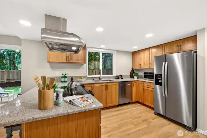 With a full suite of stainless steel appliances, generous counter space, abundant cabinetry, and new recessed lighting overhead, this kitchen is as functional as it is inviting — ready for everything from weeknight dinners to weekend gatherings.