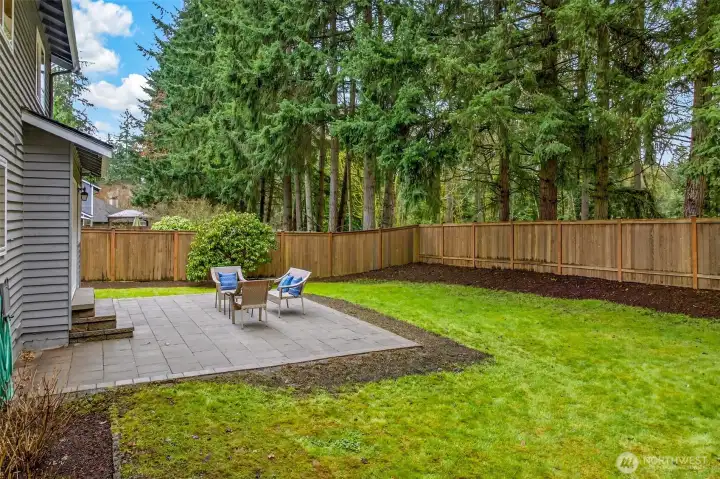 With a large paver patio, open lawn, lush landscaping, and a dramatic old-growth tree backdrop beyond the fence line, this backyard delivers the private outdoor lifestyle that draws buyers to English Hill — a setting that simply can't be replicated in a newer, denser development.