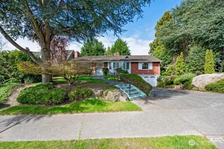 Looking west from Magnolia Boulevard. Large driveway for additional parking in front of the 2-car garage. Much parking available on the street for your guests too.