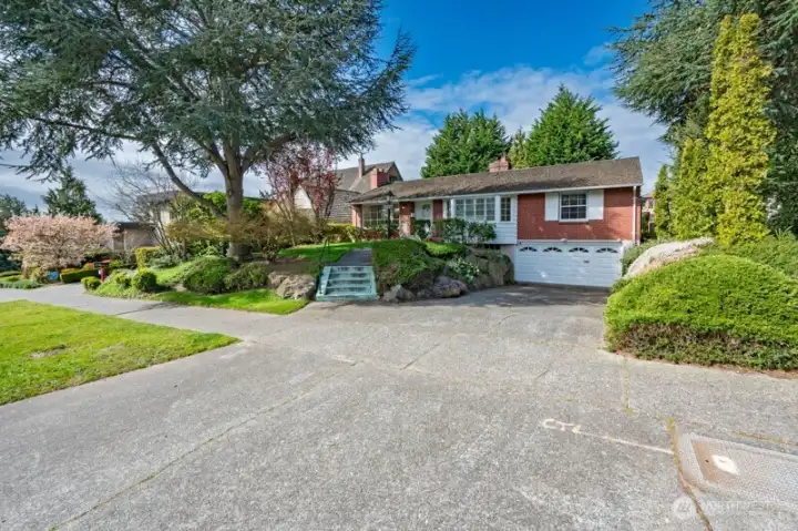 Looking southwest. Just a few steps up to the front. Generous parking space.