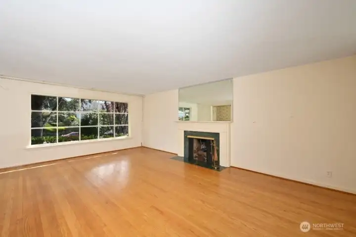 Looking east south east to the front in living room. Another huge window to light it all up.
