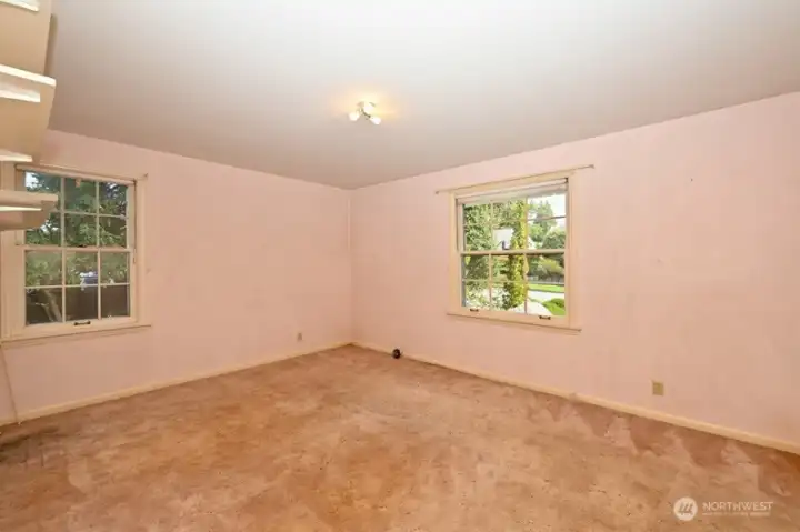 Bedroom #2 in NE corner of house. Windows to the north side and front. Again, hardwood floors underneath.
