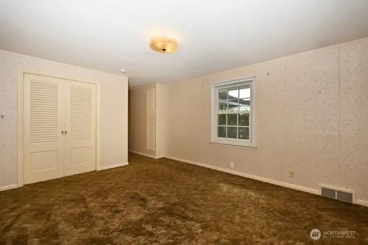 Primary bedroom looking south east. Second newer window faces south to back patio.