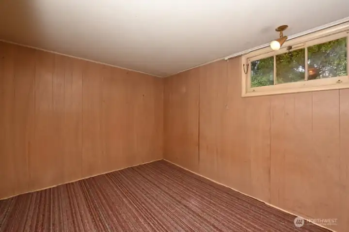 Bedroom #4 in NE corner of lower level. Now non-conforming.