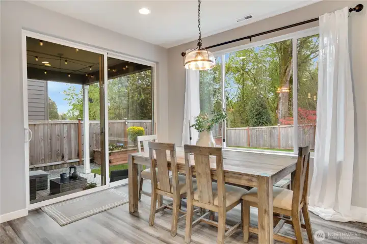 Formal dining overlooks the covered patio and private fully fenced yard.