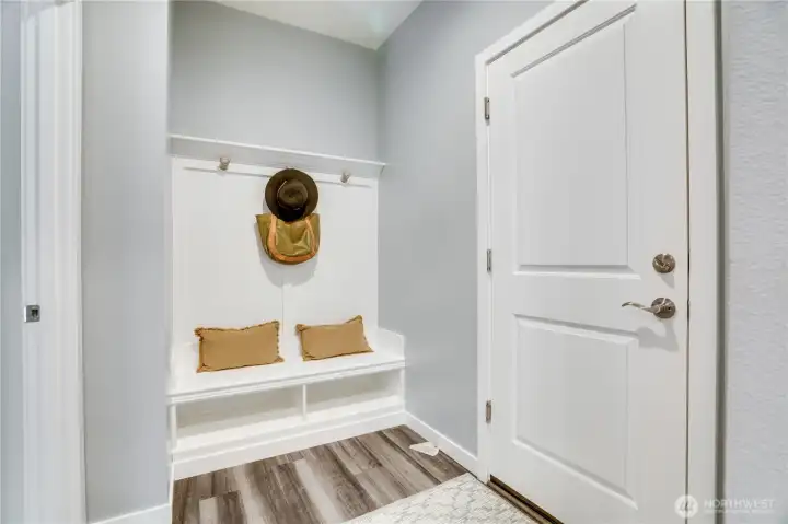 Door on the right leads to the 2-car garage. Inside garage is a level2 car charger. On the left is the Junior Suite on the main floor!