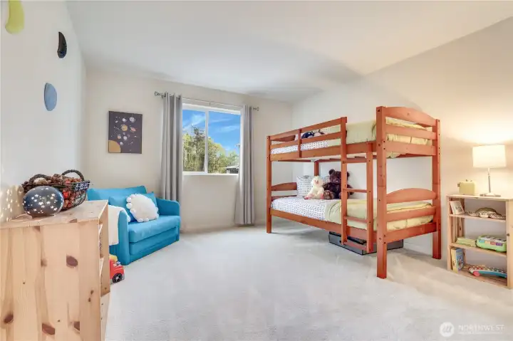 2nd bedroom upstairs overlooking the green space behind the property.