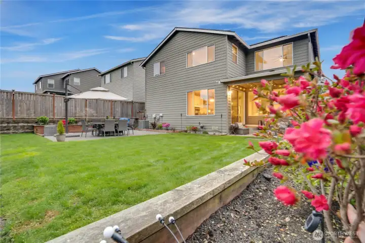 Spacious, fully fenced backyard with two patios; one covered, one uncovered