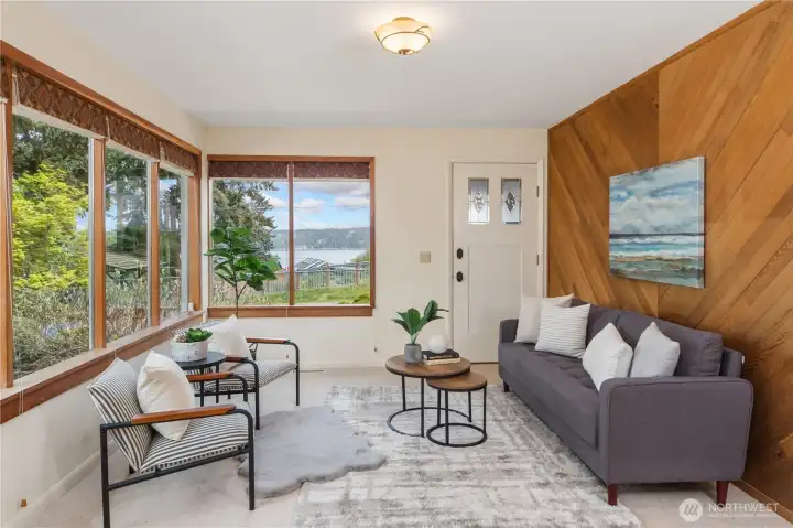Comfortable living room with wool carpet and water views.