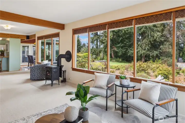 A propane freestanding stove and serene territorial backyard views offering year-round color.