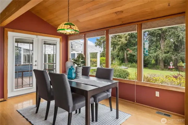 Dining room with plenty of natural light and french doors that lead to the new deck.