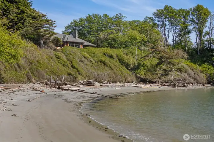 Perched dramatically above a pristine driftwood-strewn beach, this stunning home commands sweeping waterfront views from its elevated bluff position on Kanaka Bay. The private, secluded setting offers the ultimate San Juan Island lifestyle just steps from the water's edge.