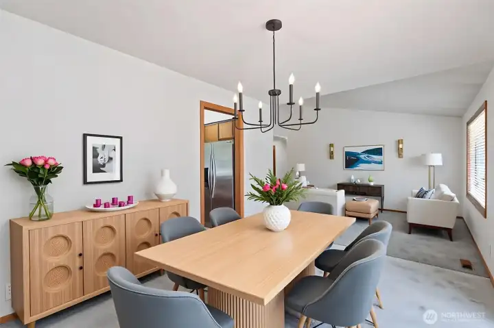 This stunning open-concept layout is brought to life through virtual staging, highlighting the seamless transition between the dining area and the living room. The vaulted ceilings and rich hardwood floors create an expansive atmosphere, while the direct deck access makes this the ultimate "Great Room" for year-round enjoyment. This stunning open-concept layout is brought to life through virtual staging, highlighting the seamless transition between the dining area and the living room. The vaulted ceilings and rich hardwood floors create an expansive atmosphere, while the direct deck access makes this the ultimate "Great Room" for year-round enjoyment.