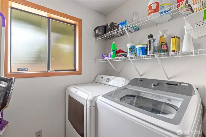 The laundry area is designed for efficiency, offering a well-maintained washer and dryer alongside ample shelving for easy organization. This pristine room highlights the home’s functional design, providing the perfect spot for extra household storage in a convenient, single-story layout. The laundry area is designed for efficiency, offering a well-maintained washer and dryer alongside ample shelving for easy organization. This pristine room highlights the home’s functional design, providing the perfect spot for extra household storage in a convenient, single-story layout.