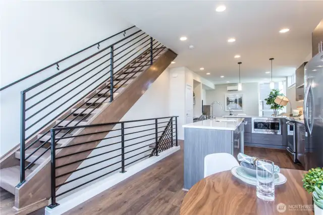 Stairs from the lifestyle level to the upper bedroom level are custom constructed and stained.  Metal railings add to the contemporary look.  The open stairs are a unique feature of these homes and allow natural light to flood through them.