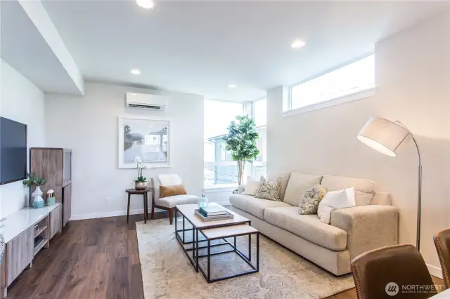 Large living room has ample space for a sectional, chairs, and entertainment center.  This picture does not do that space justice!