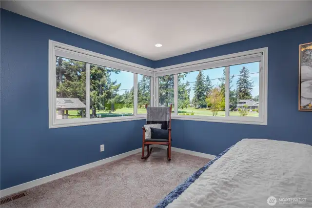wake up to the sunshine and the gorgeous golf course greens in this expansive primary suite!