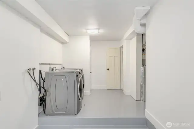Large laundry room with closets and storage