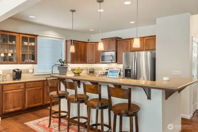 The kitchen is the center of this home and features granite counters, including the island with lots or room, top quality appliances and undercabinet lighting. All of the appliances are included in the sale!