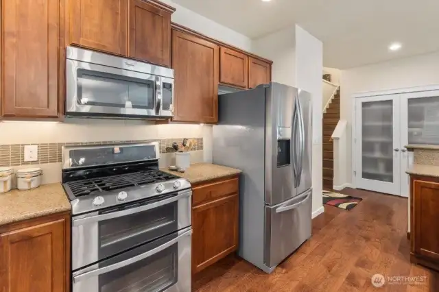 Double oven and SS microwave and refrigerator.