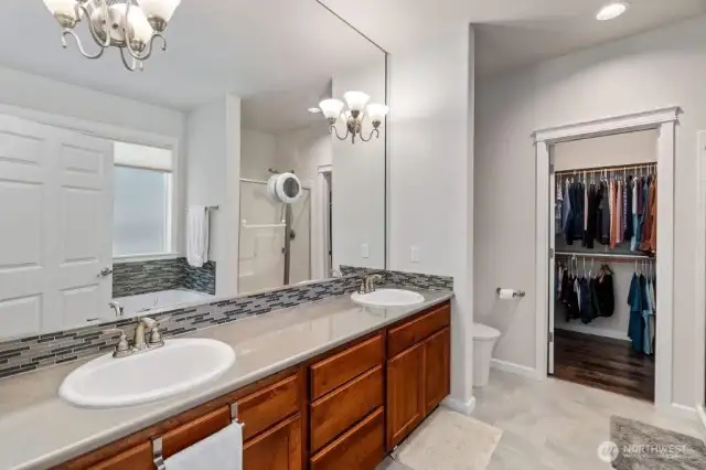 Primary bathroom with quartz counters, a bidet, large walk in closet, step in shower and amazing 24 jet soaking tub.