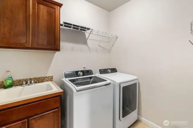 Nice laundry room with sink and cabinets. Washer and dryer are included.