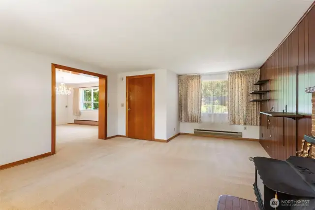 Another view of the living room looking at the front door and going into the dining room