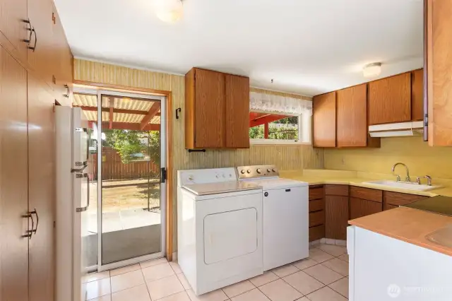 Cozy kitchen.  The wall on left is all storage.  Looking out to backyard