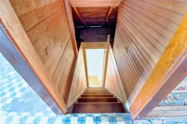 Steep stairs leading to attic storage space from bedroom 2