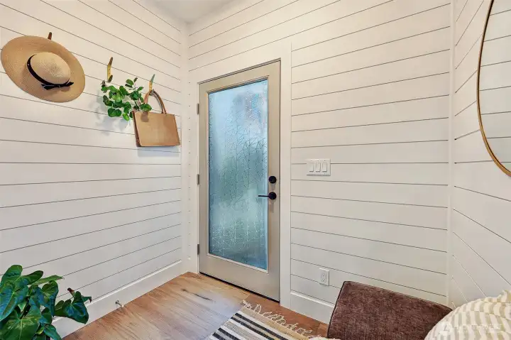 Mudroom leads to the private parking space for this home.