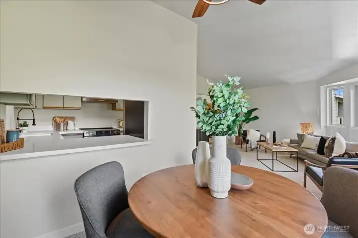 Pass-through window to the kitchen adds effortless flow for meals and gatherings.